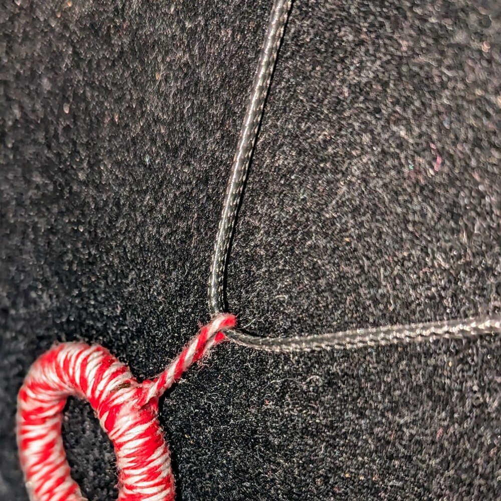 A new simple twine necklace hung on string with a chain clasp